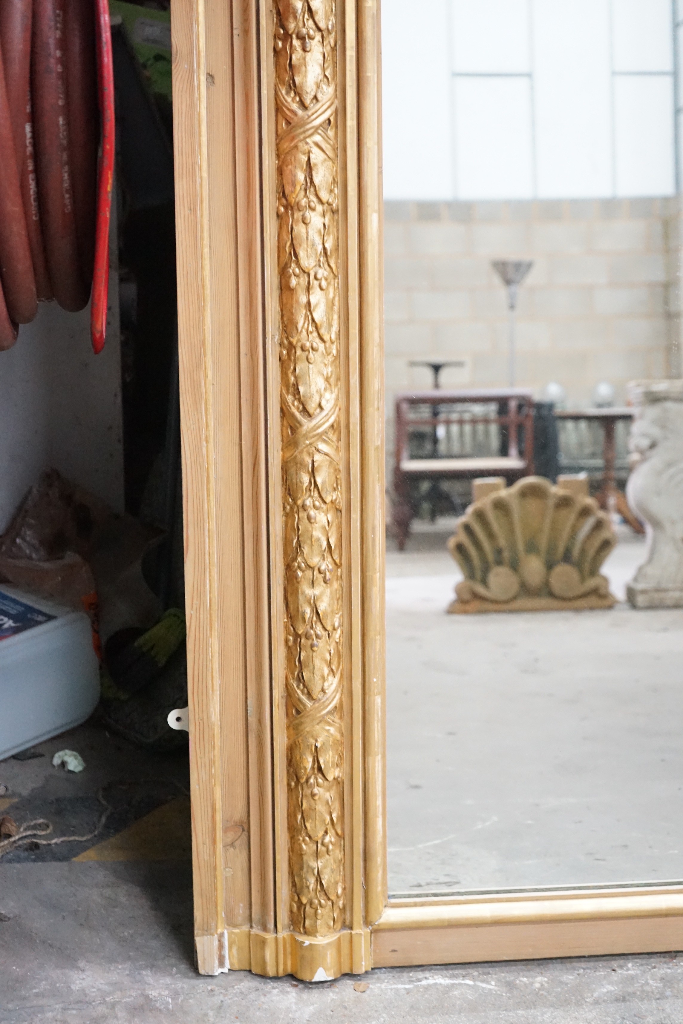 A Victorian pitch pine and gilt composition wall mirror the arched plate with floral vase surmount, width 117cm, height 212cm